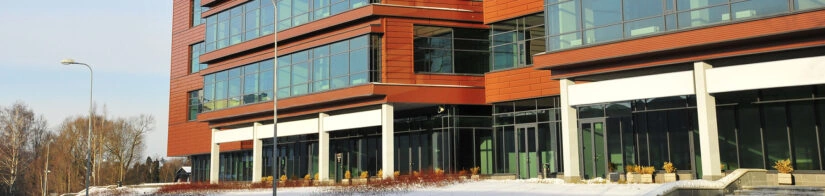 A modern glass and red-brick building, representing commercial pest control Mequon services